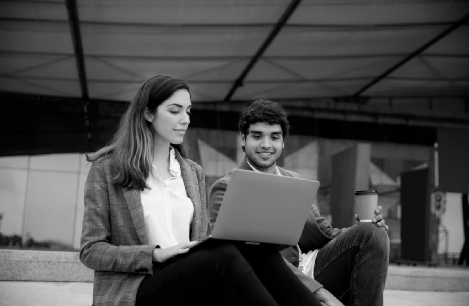 Student reviewing financial planning materials with advisor in bright study space